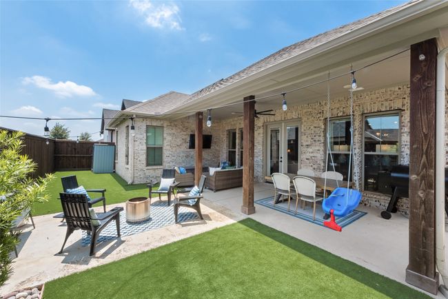 View of patio featuring ceiling fan, french doors, and an outdoor living space with a fire pit | Image 36