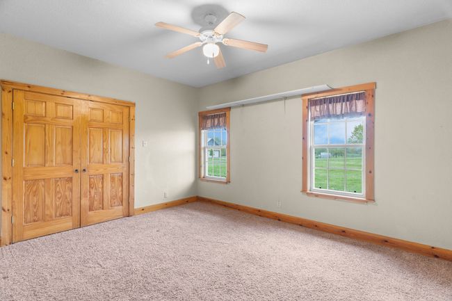 Unfurnished bedroom with carpet floors, baseboards, and ceiling fan | Image 27
