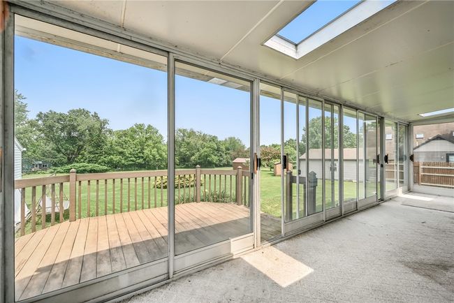 Sunroom offers washer/dryer hook up for 1st floor laundry. scenic view & exits to back deck | Image 5