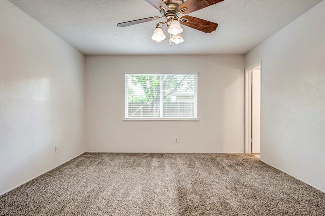 Spare room featuring carpet flooring and a ceiling fan | Image 25