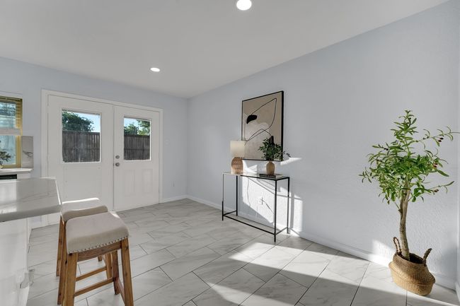 Entrance foyer featuring light marble finish floors, healthy amount of natural light, and recessed lighting | Image 32