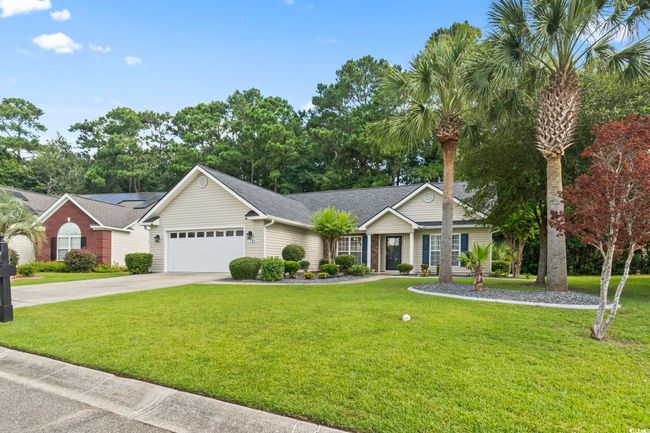 Ranch-style house with driveway, a garage, a front lawn, and a shingled roof | Image 31