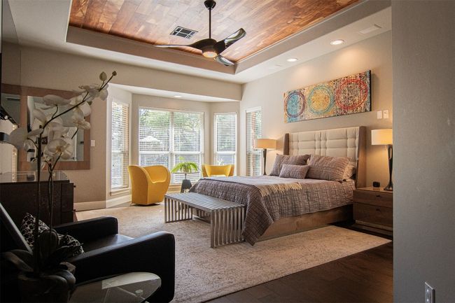 Bedroom featuring a tray ceiling, wooden ceiling, wood finished floors, baseboards, and recessed lighting | Image 16