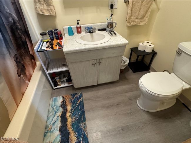 Bathroom with toilet, wood finished floors, vanity, and baseboards | Image 21
