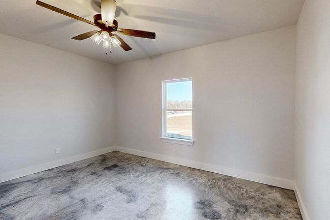 Unfurnished room with carpet flooring, baseboards, and ceiling fan | Image 32