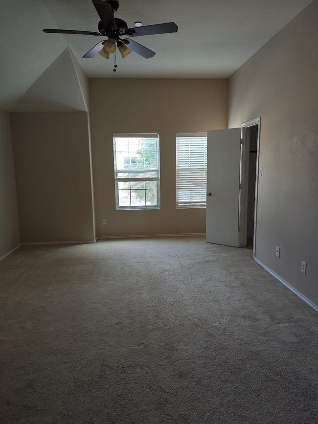 Spare room with ceiling fan, baseboards, and light carpet | Image 11