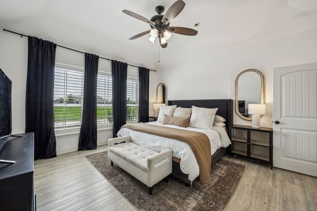 Bedroom with wood finished floors and a ceiling fan | Image 10