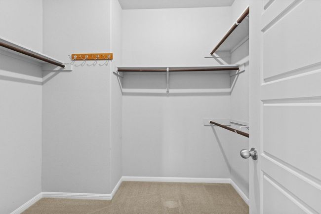 Walk in closet with carpet floors | Image 29