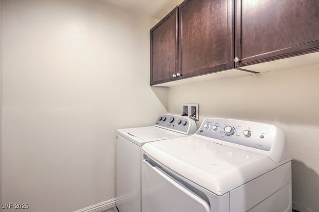 Laundry area with cabinet space, baseboards, and washer and dryer | Image 29