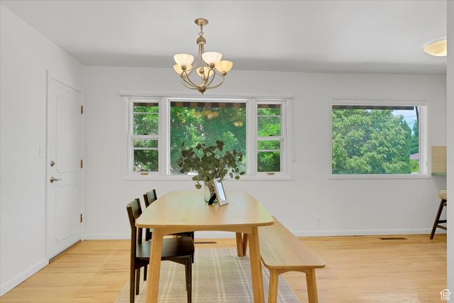 Dining room featuring a chandelier, light wood-style floors, and plenty of natural light | Image 6