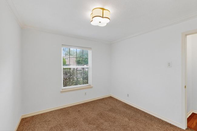 Carpeted empty room featuring crown molding and baseboards | Image 29