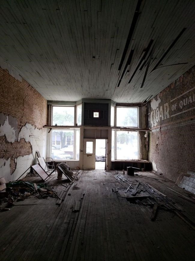 Misc room featuring hardwood / wood-style floors and brick wall | Image 5
