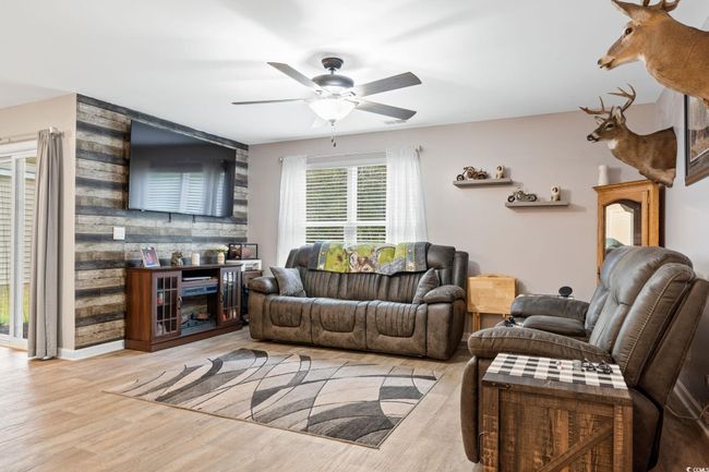 Living room with ceiling fan and light hardwood / wood-style flooring | Image 7