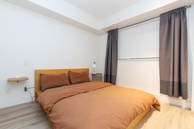 Bedroom with light wood-type flooring and baseboards | Image 11