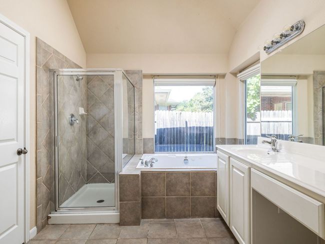 Main bathroom's en-suite bathroom has abundant light, and vaulted ceilings! | Image 12