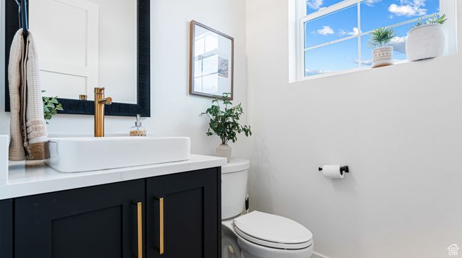 Bathroom with toilet, vanity, and baseboards | Image 28