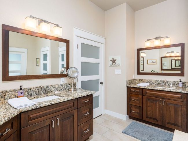 Renovated primary bathroom with extra large walk in shower and double vanities. | Image 16
