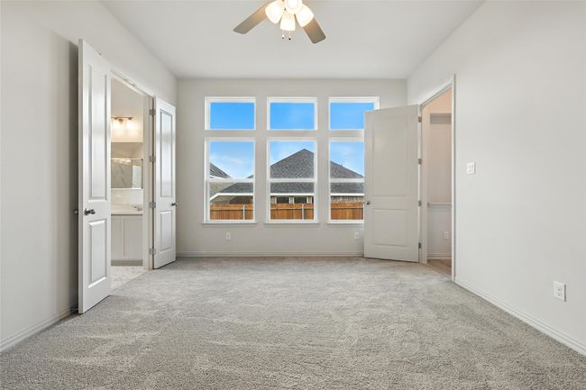 Unfurnished bedroom featuring carpet, connected bathroom, and ceiling fan | Image 19