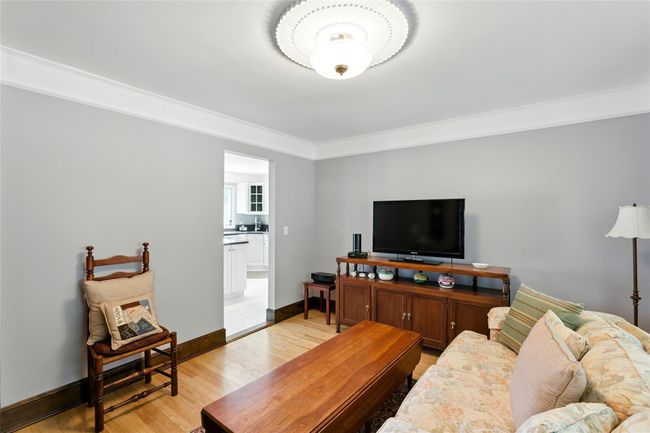Living area with light wood-style flooring and crown molding | Image 27