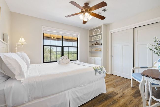 Bedroom featuring wood finished floors, a closet, and ceiling fan | Image 20