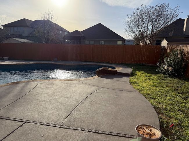 View of pool featuring a patio area, a fenced backyard, and backyard fence all throughout. | Image 36