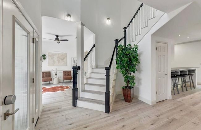 Foyer entrance featuring light wood-style floors, stairs, and ceiling fan | Image 8