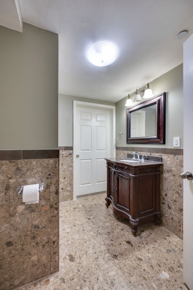 Full bathroom in the basement features an extra large closet. | Image 39