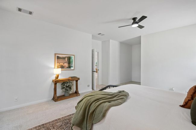 Bedroom with carpet, visible vents, baseboards, and ceiling fan | Image 16