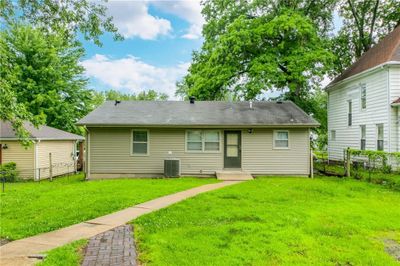 Back of property featuring a yard and central AC | Image 3