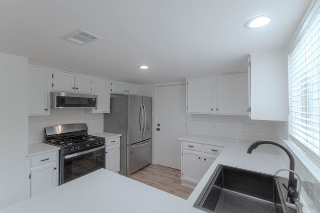 The counter tops are white quartz. | Image 9