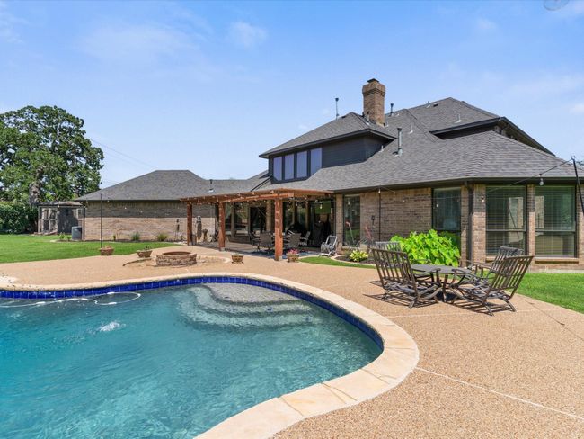 Swimming pool featuring an outdoor fire pit, a patio, and a pergola | Image 32
