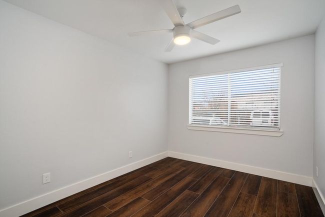 Empty room featuring dark wood-style floors and a ceiling fan | Image 13