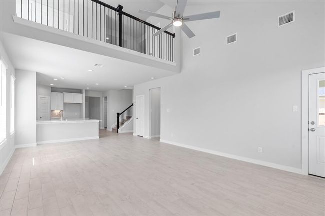 Additional view taken from Family Room looking towards kitchen and a view of the second floor with the beautiful metal balusters! | Image 9