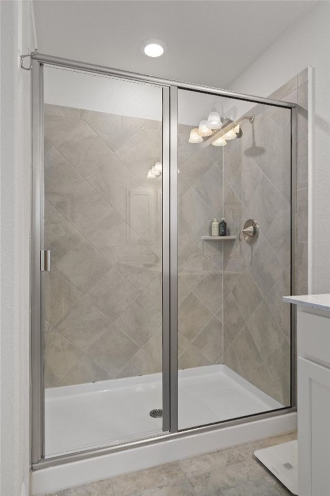 Full bath featuring a stall shower, vanity, and recessed lighting | Image 21