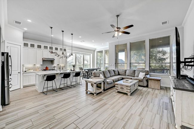 Wood-look tile flooring extends throughout the living areas, adding a modern touch to the warm and cozy ambiance of the living room. | Image 4