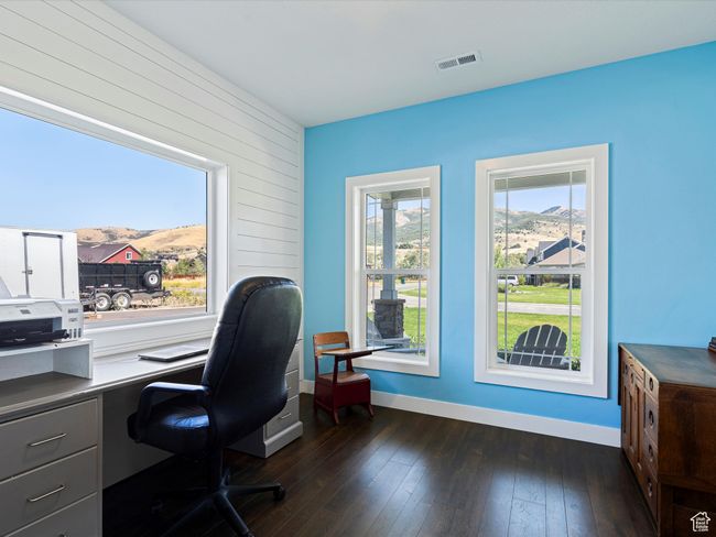 Home office featuring a mountain view, baseboards, and dark wood finished floors | Image 18
