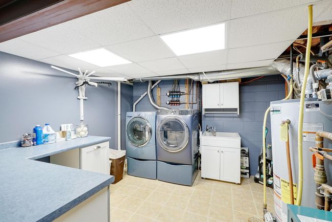 Spacious laundry with plenty of counter space. | Image 35