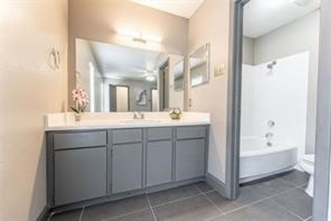 Bathroom with tile patterned floors, vanity, bathtub / shower combination, and a ceiling fan | Image 26