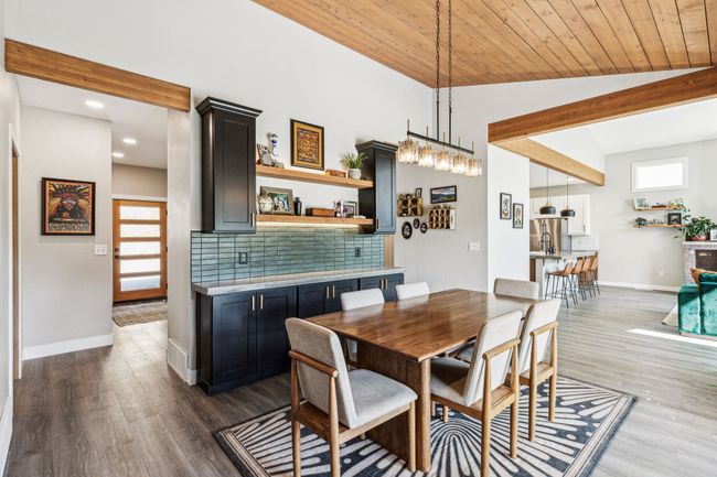 Dining space featuring vaulted ceiling, wood finished floors, baseboards, and recessed lighting | Image 12