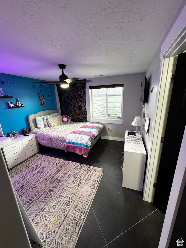 Bedroom with a textured ceiling, a ceiling fan, and baseboards | Image 20