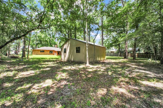 Tucked away in the backyard, the storage shed offers a convenient solution for tools, seasonal décor, and everything in between. | Image 34