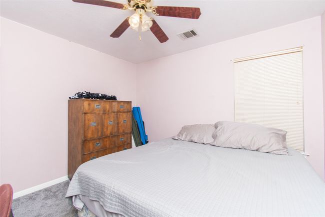 Carpeted bedroom featuring visible vents, baseboards, and a ceiling fan | Image 14