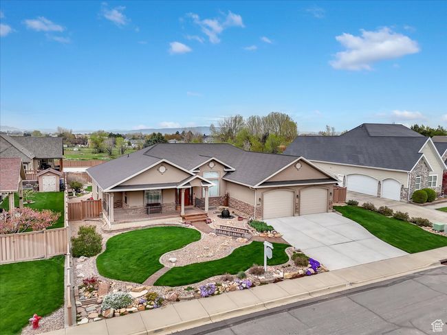 View of front of house featuring concrete driveway, an attached garage, a porch, and a front yard | Image 37