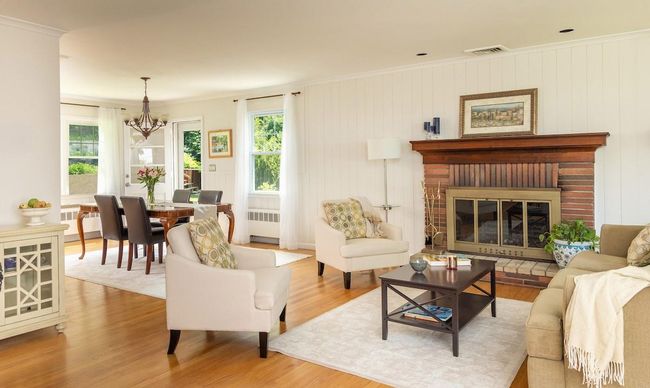 Living room with raised hearth fireplace with view to dining room | Image 4
