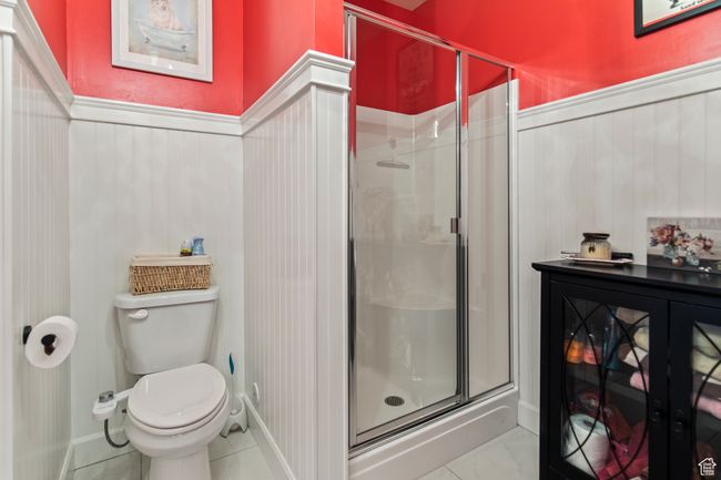Bathroom with tile patterned floors, toilet, and walk in shower | Image 68
