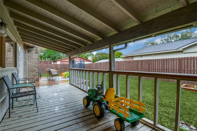 Wooden deck overlooking a fenced backyard | Image 23
