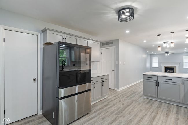 kitchen with gray cabinets, light wood-style flooring, baseboards, recessed lighting, and plenty of natural light | Image 13
