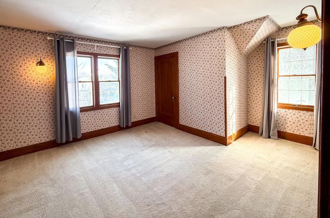 Bedroom three offers a traditional layout with plenty of natural light to flow throughout. | Image 23