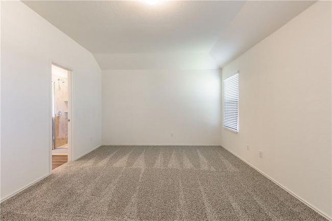 Spare room featuring carpet flooring and lofted ceiling | Image 7