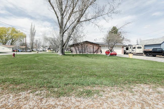 View of yard with an attached garage and driveway | Image 46